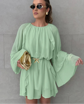 Empire waist green mini swing dress featured as airy day party outfit